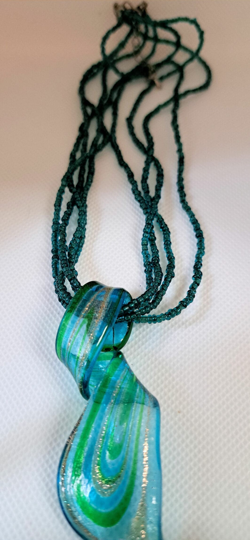 Multistrand green necklace with glass focal Multistrand green necklace