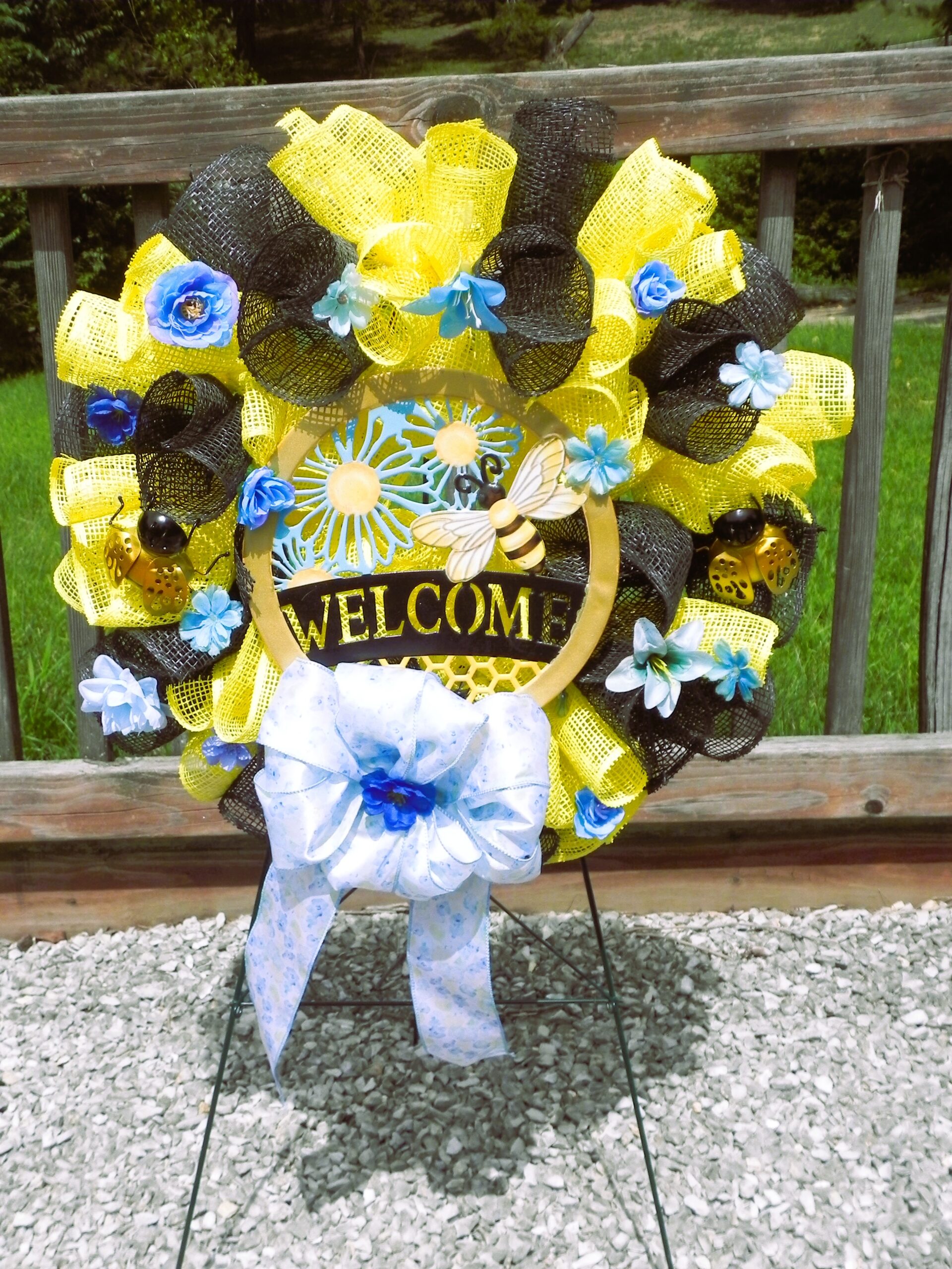 Vibrant black & yellow “welcome” wreath with bee accents Vibrant black & yellow “welcome” wreath with bee accents