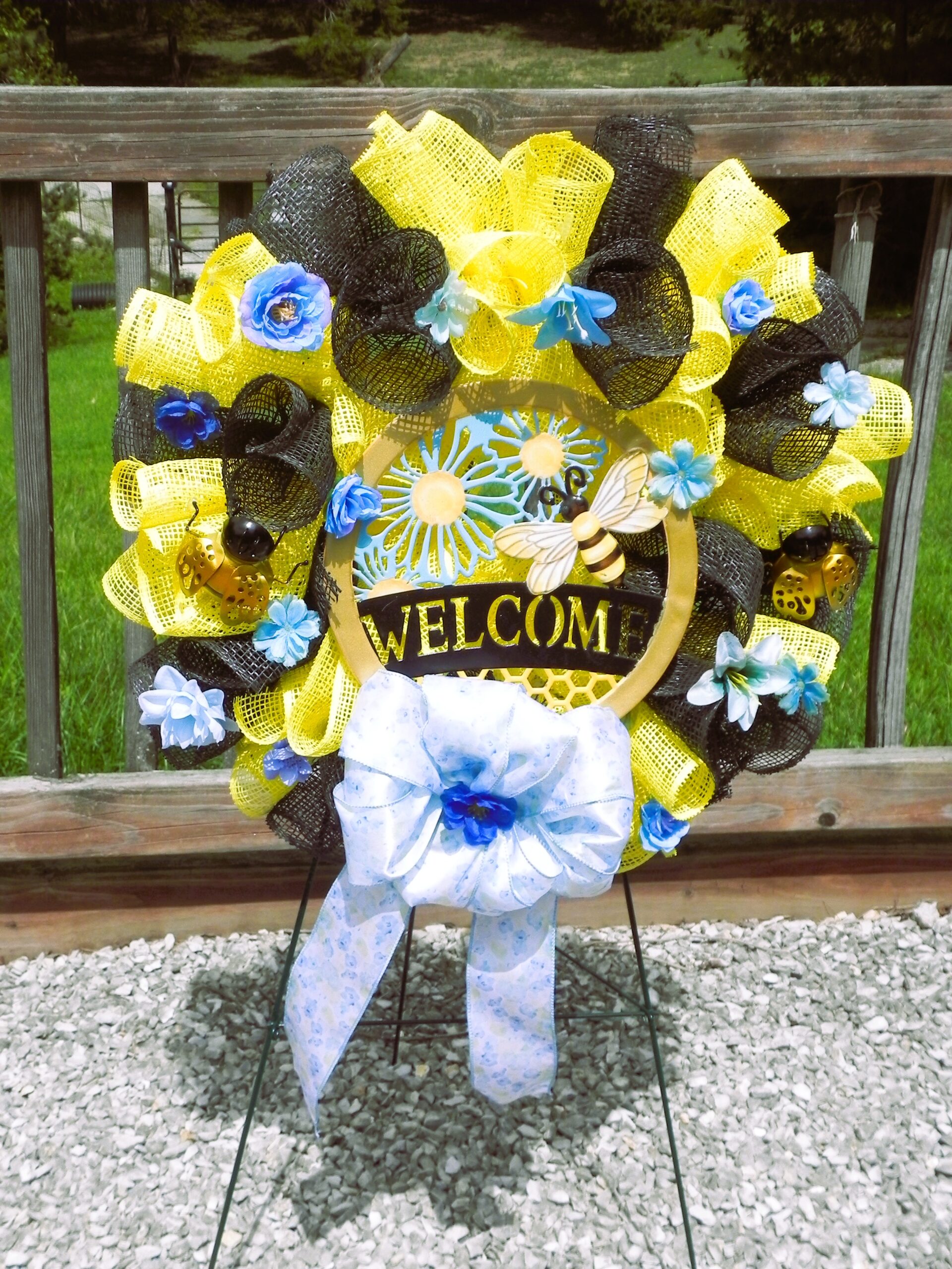 Vibrant black & yellow “welcome” wreath with bee accents Vibrant black & yellow “welcome” wreath with bee accents