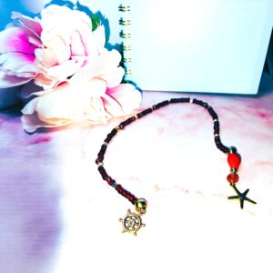Red glass beaded bookmark with ocean themed gold tone charms