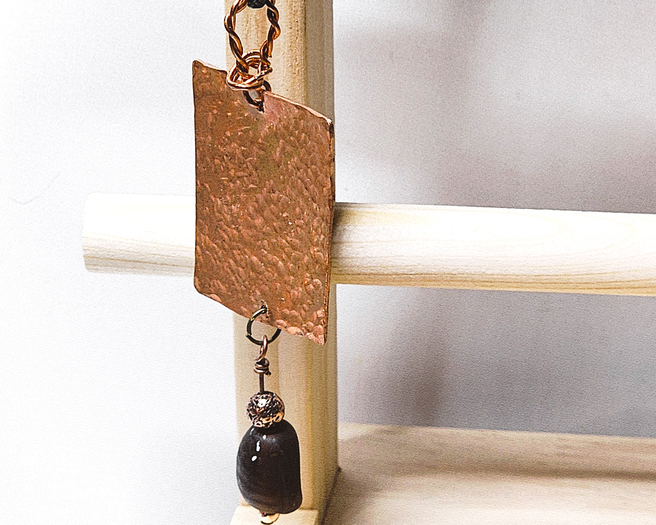 Hammered copper pendant necklace with dark stone accent Hammered copper pendant necklace with dark stone accent