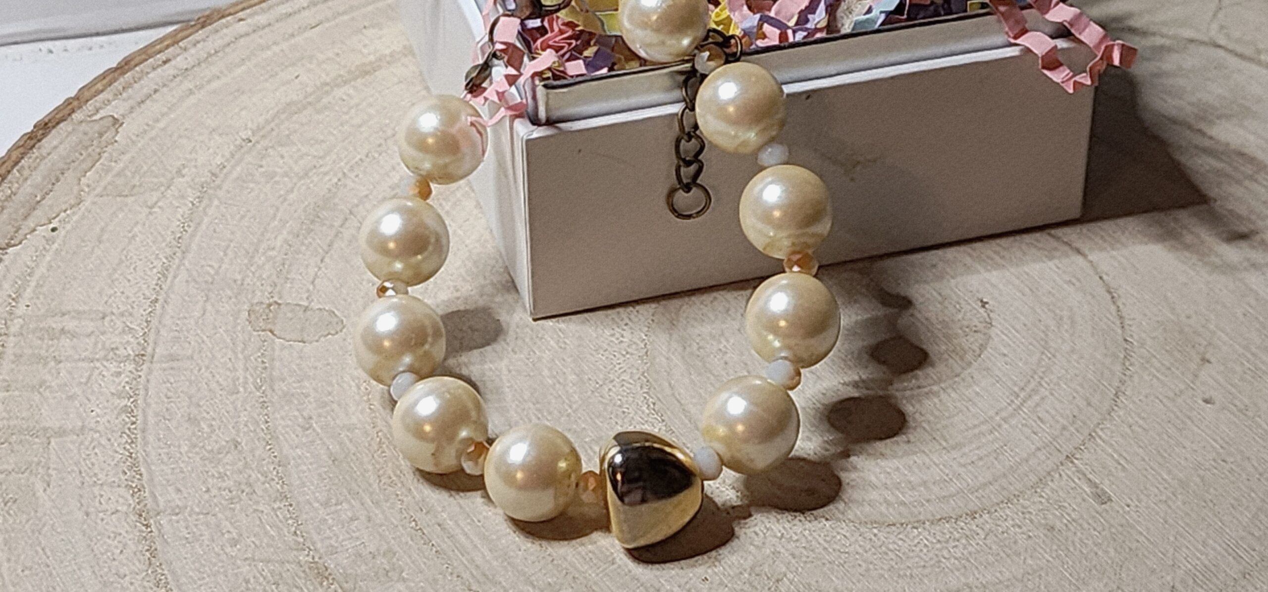 Faux pearl cream colored beads and gold colored glass accent bead Faux pearl cream colored beads and gold colored glass accent bead
